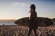 © Mauro Grigollo/Stocksy - Woman ready for surfing
