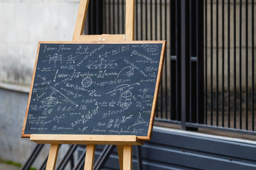 Wall Mural - Math text with some maths formulas on chalkboard background