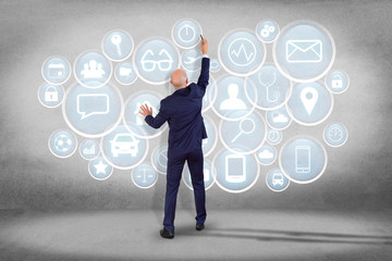Poster - Businessman in front of an interface of different mixed application - technology concept