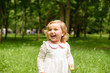 © Nestyda - Beautiful little blonde girl, has happy fun cheerful smiling face, white dress. Portrait nature.