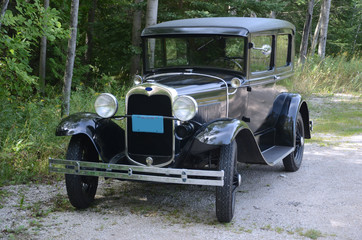 Antique auto on country lane