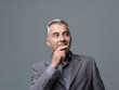 © stokkete - Smart businessman thinking with hand on chin