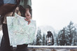 © Alex from the Rock - Woman standing in the wild with map and oil lamp. Close-up. Winter is coming, first snowfall. Wanderlust and boho style