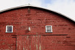 © Natalie JEFFCOTT/Stocksy - close up photo of old red wooden barn in the country
