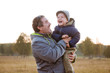 © Anna - Dad plays with his son in autumn forest.