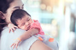 © pingpao - Cute asian newborn baby girl sleeping on mother's shoulder.Young mother cuddling baby with tenderness.