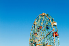 Ferris Wheel Detail Against Blue Sky At An Amusement Park