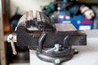 Hand on gray bench vise closeup. Side view