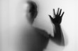 © bubbers - Shadow blur of horror man.Dangerous man behind the frosted glass.Mystery man.Black and white picture.Blur picture.Add effects noise and grain.Halloween.Halloween.