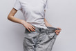 © SHOTPRIME STUDIO - a woman in a white T-shirt and pants that are too big for her