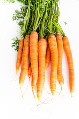 Wall Mural - Fresh carrots with leaves, on white background