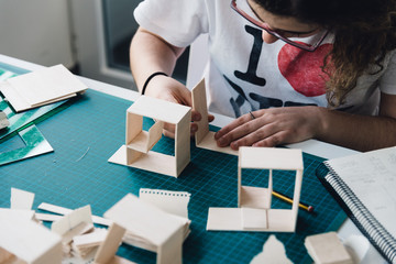 woman architecture student working on models