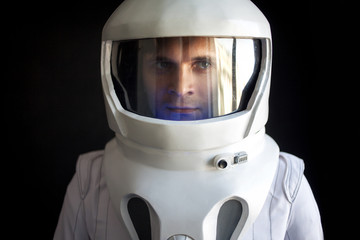 Wall Mural - Astronaut in a helmet looks down. Fantastic space suit. Exploration of outer space.