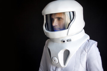 Wall Mural - Astronaut in a helmet looks down. Fantastic space suit. Exploration of outer space.