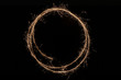 Circle made with sparkler on black background.