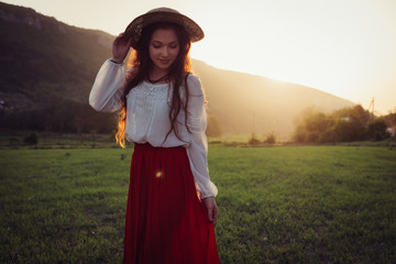 happy laughing girl holding straw walking in the green summer park