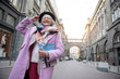 © Yakobchuk Olena - Happy fashionable mature lady enjoying travel in city