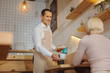 © Viacheslav Yakobchuk - Happy positive waiter looking at his customer