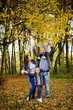 © AS Photo Family - Happy caucasian family of mom dad and little girl with boy at majestic autumn fall forest.