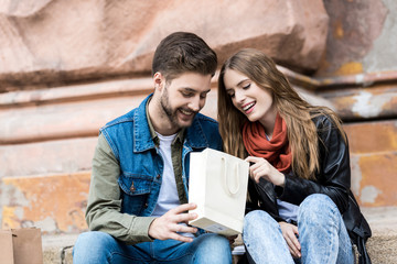 Wall Mural - couple looking into shopping bag