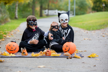 Sticker - Two children, boy brothers in the park with Halloween costumes