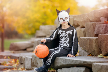 Canvas Print - Cute child, boy dressed in halloween costume, playing in the park