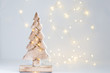 Hand made wooden Christmas tree and Christmas light on white background.