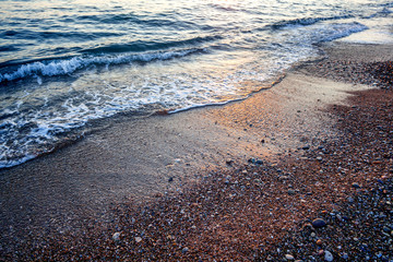 Wall Mural - sea wave and pebble shore close-up, abstract natural background