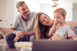 Happy young family watching movie