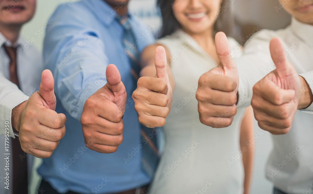 Cheerful business group giving thumbs up. Group of happy multiracial businesspeople gesturing thumb up sign. - obrazy, fototapety, plakaty 