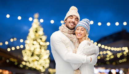 Canvas Print - happy couple hugging over christmas tree lights