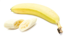 One Whole Yellow Banana And Two Peeled Slices Isolated On White Background
