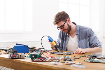 Poster - Technician repairing motherboard by air dryer