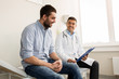 © Syda Productions - smiling doctor and young man meeting at hospital