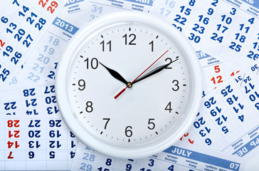 Wall Mural - clock with wall calendar sheets with the number of days