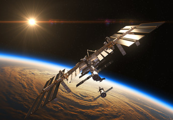 Wall Mural - international space station and spacecraft in the background of rising sun