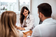 © bnenin - Family couple sitting in doctor's office at consultation.