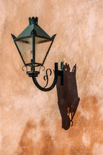 Traditional Street Lamp Attached To A Vibrant Orange Wall