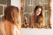 © Guille Faingold/Stocksy - beautiful Peruvian woman smiling in a mirror