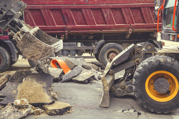 Excavator and truck removes old asphalt 2