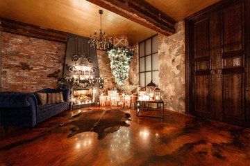 alternative tree upside down on the ceiling. Winter home decor. Christmas in loft interior against brick wall.