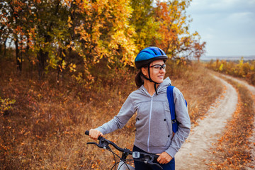 Wall Mural - Young woman riding a bicycle in the field