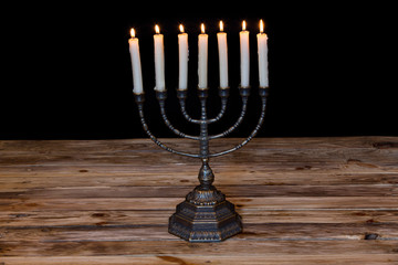 Ancient ritual candle menorah on a black background