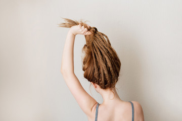 Ginger woman with dreadlocks. Interesting hairstyle