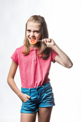 beautiful little girl with a lollipop in hands. happy little girl. emotions of the child.