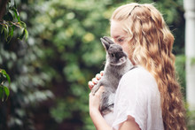 Teenage Girl With A Small Grey Rabbit