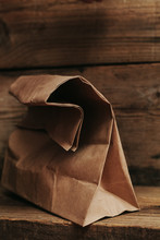Brown Paper Bag On Wooden Background
