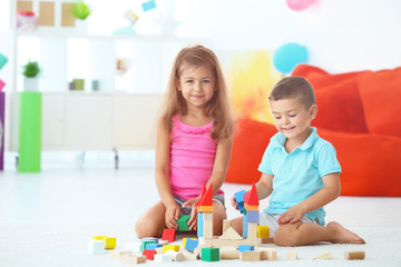 Canvas Print - Cute children playing with blocks indoor