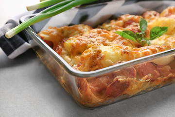 Canvas Print - Delicious sausage casserole in baking dish on table, closeup