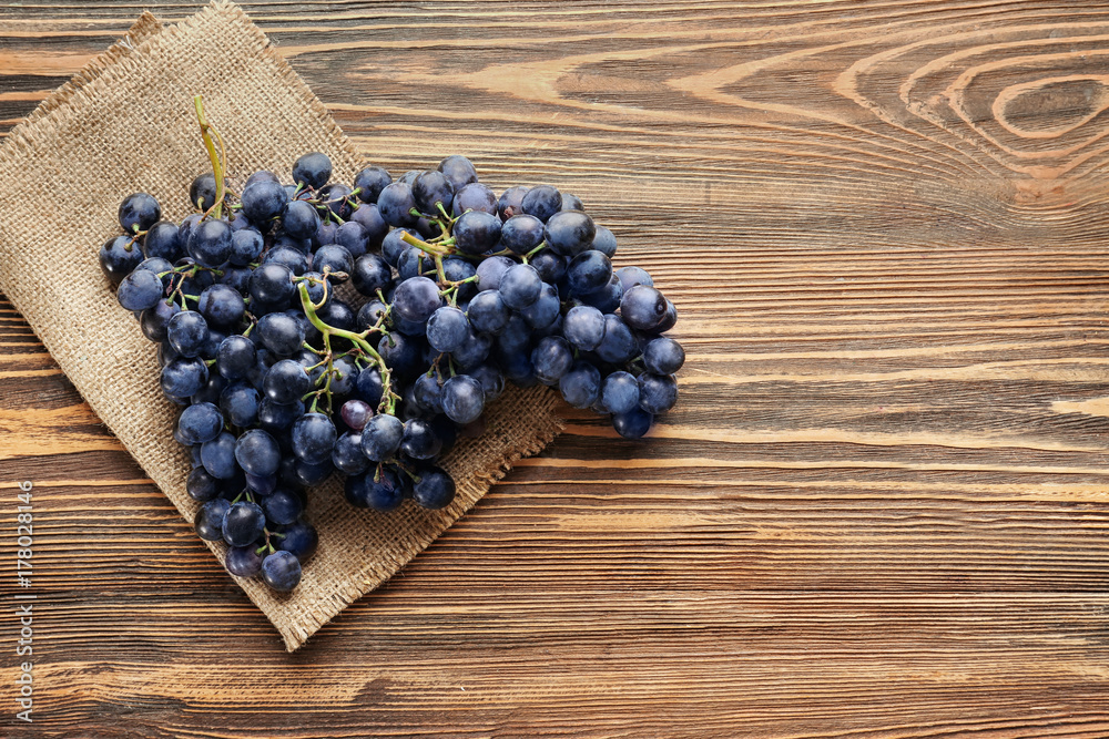 Fresh ripe grapes on wooden background